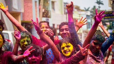 People celebrating Holi festival with colored powder on Holi Date