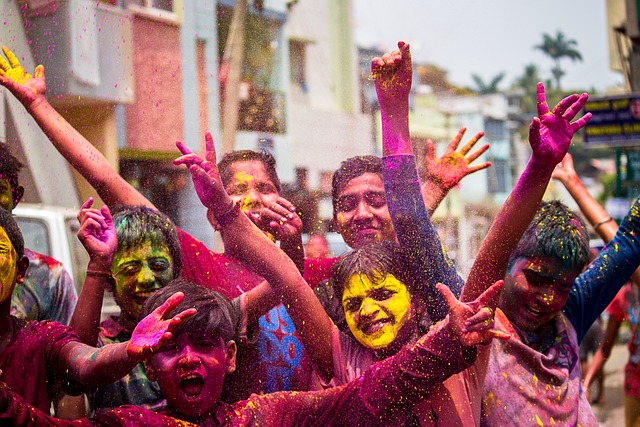 People celebrating Holi festival with colored powder on Holi Date